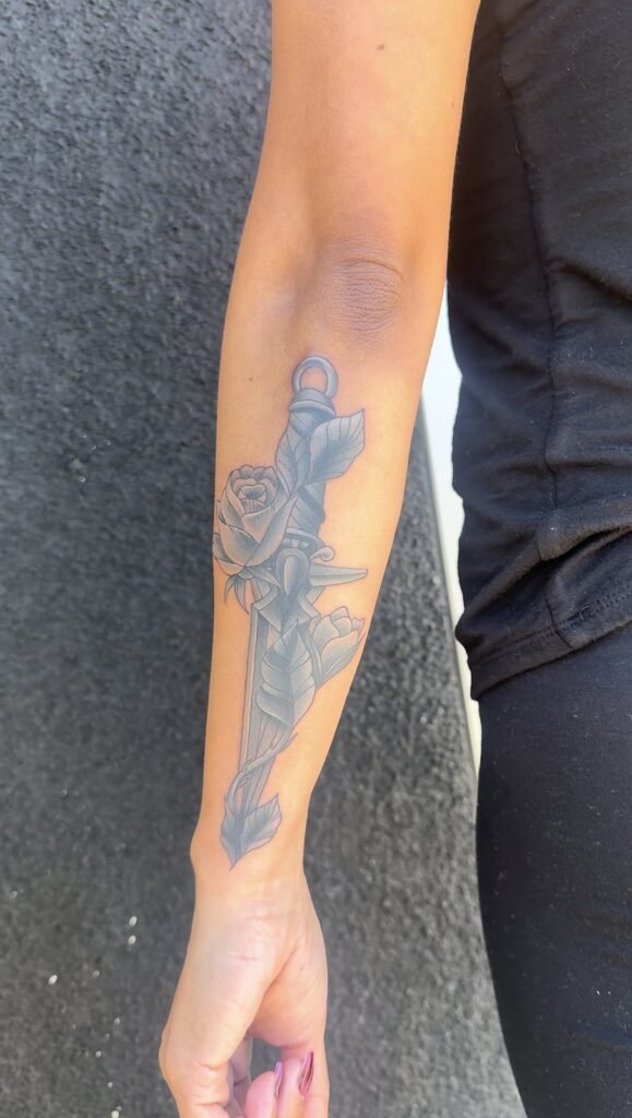 Dagger and rose forearm tattoo by Monique Andujo, Murrieta CA