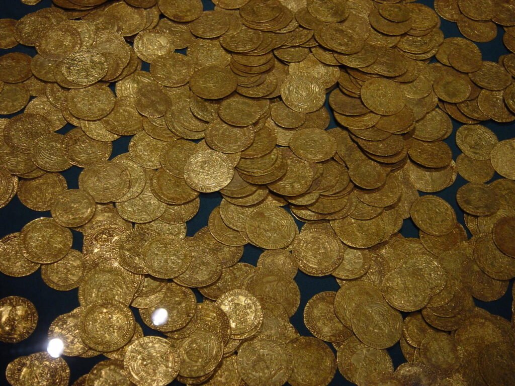 A hoard of ancient gold coins on a dark display