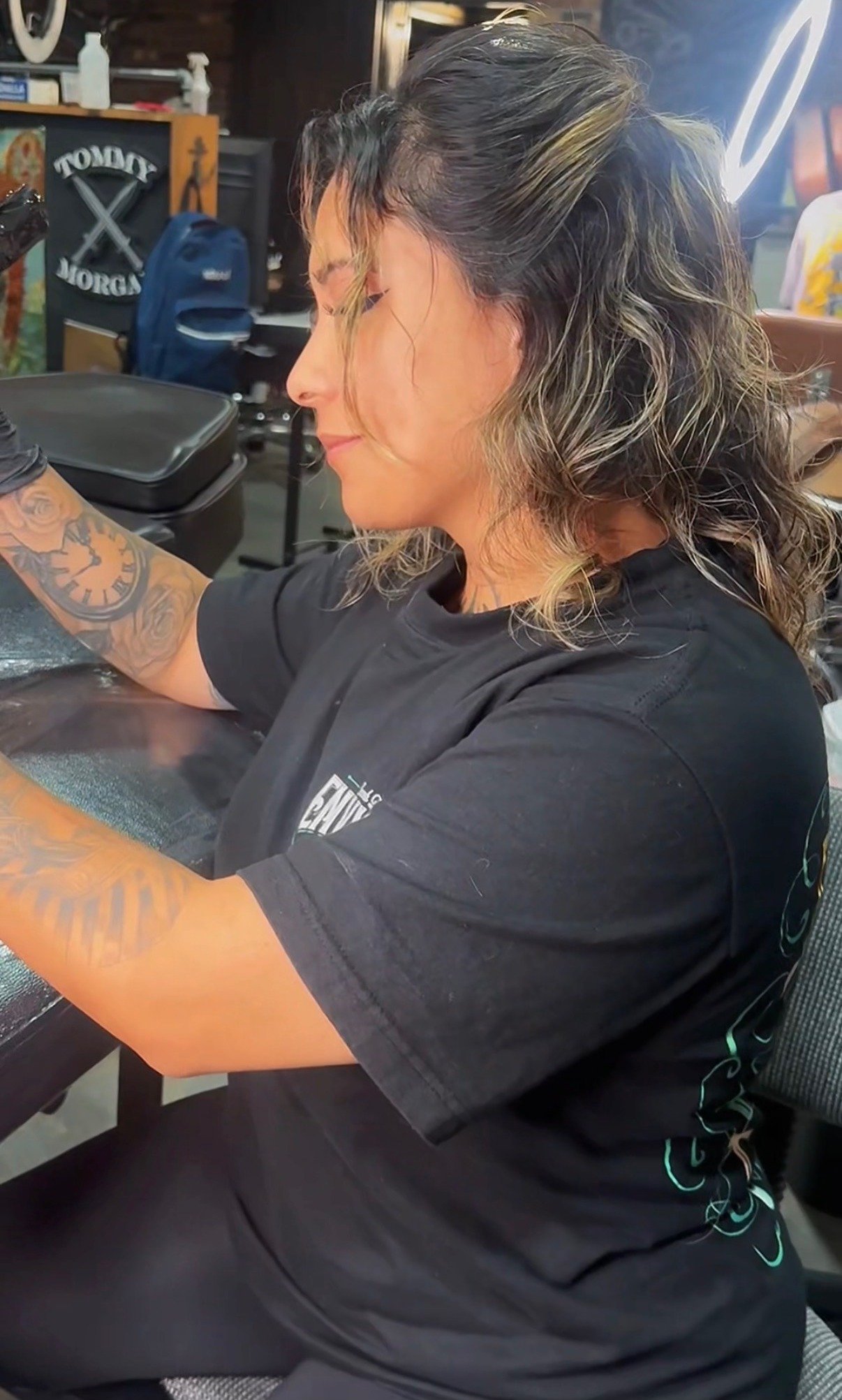 Monique Andujo tattooing a client